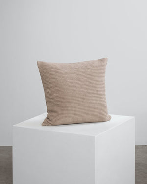 beige scatter cushion on a cube. 