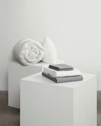 Light grey striped move-in set. Including duvet, pillows, duvet cover, fitted sheet and two pillowcases. 
