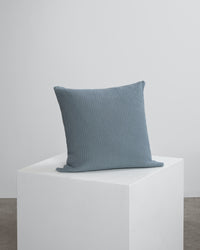 arctic blue waffle scatter cushion on cube.