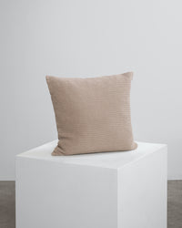 beige scatter cushion on a cube. 