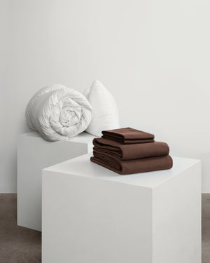 Acorn brown move-in set including fitted sheet, duvet cover, 2 pillowcases, 2 pillows and a duvet.