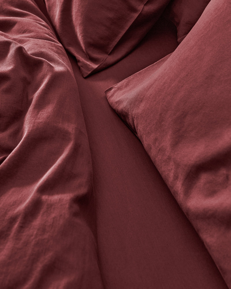 close up of burgundy bedding.