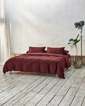 lifestyle image of burgundy bedding.