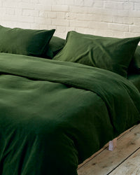 close up shot of dark green bedding. 