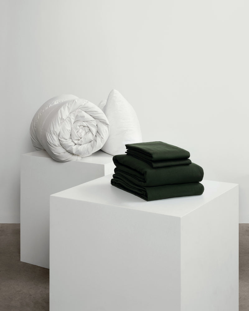 dark green bedding set with duvet and pillows.
