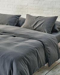 dark grey bedding set in an industrial bedroom