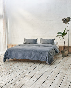 Lifestyle image of graphite blue bedding. 