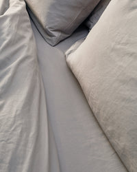 silver grey bedding set in an industrial bedroom