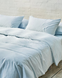 light blue bedding set in an industrial bedroom
