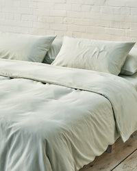 light green bedding set in an industrial bedroom