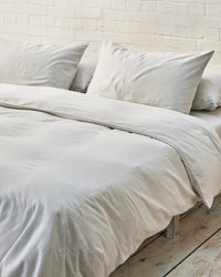 light grey bedding set in an industrial bedroom