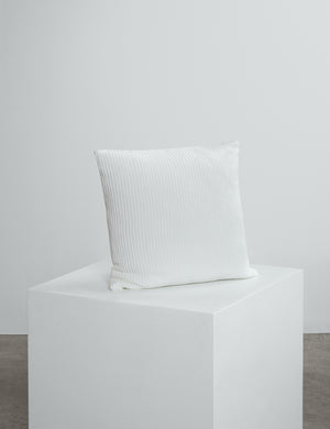 white waffle scatter cushion on cube. 