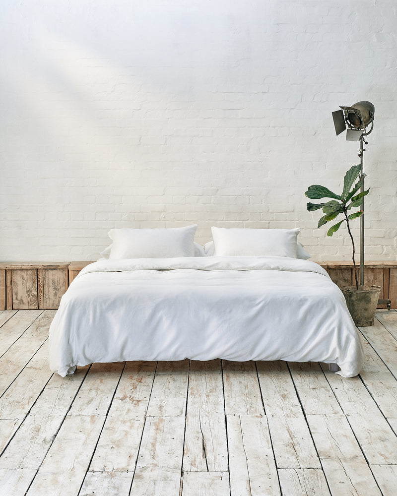 White bedding set in an industrial bedroom